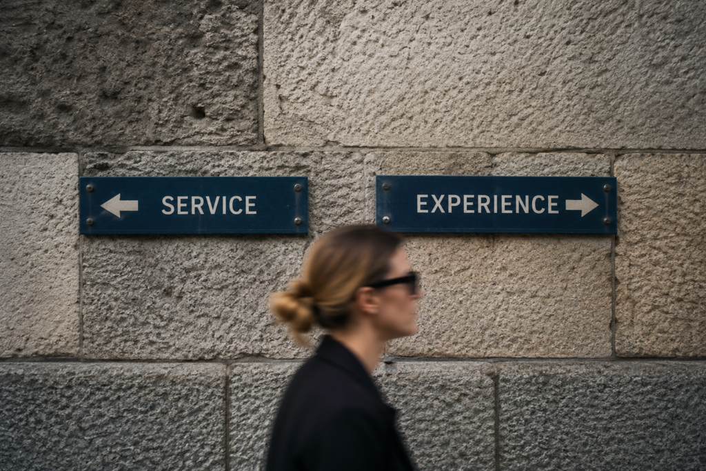 A person walking past a stone wall with two directional signs pointing in opposite directions labelled “Service” and “Experience,” illustrating the choice between customer experience vs service.